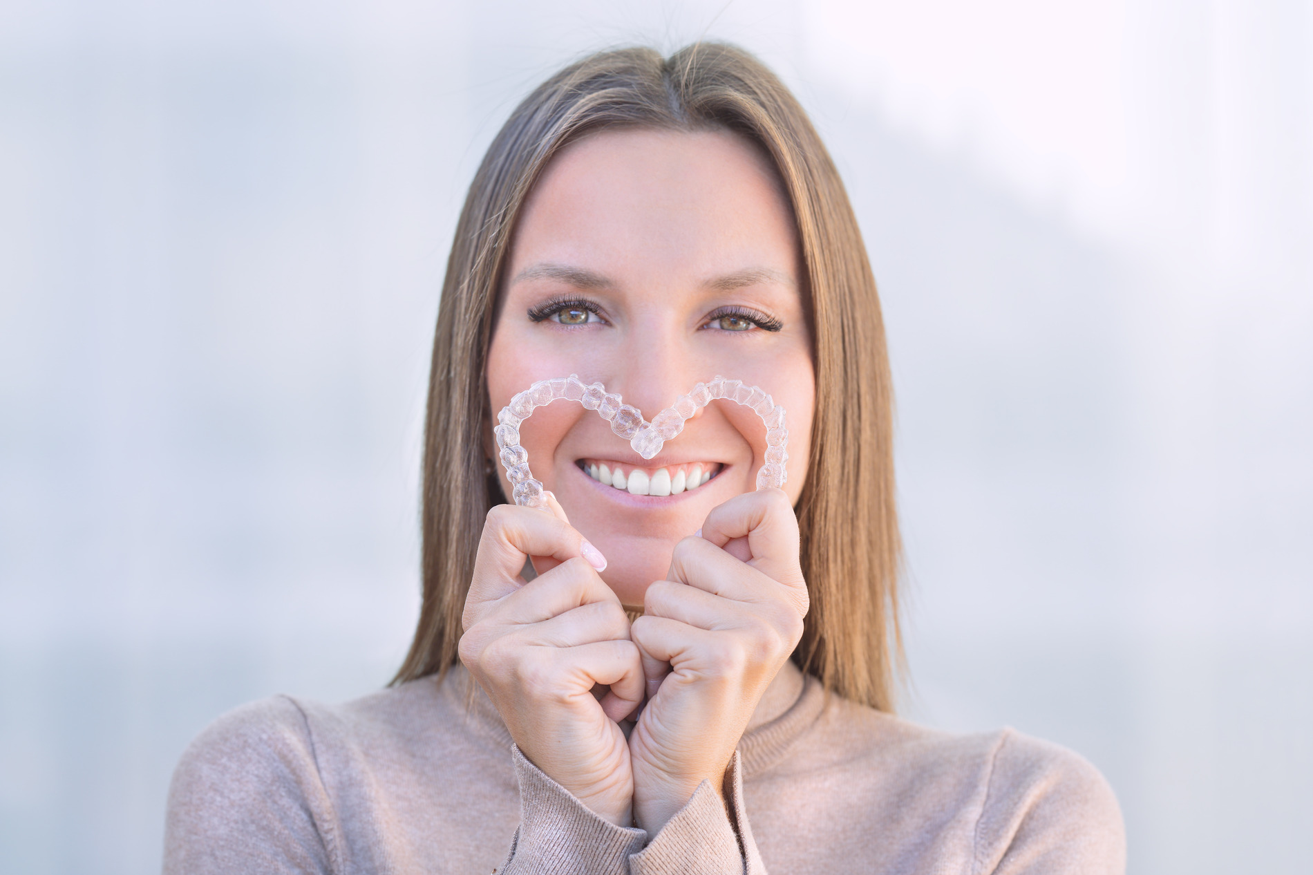 AdobeStock_470935822 v2 Woman shows off her invisalign treatment in Crestview Hills