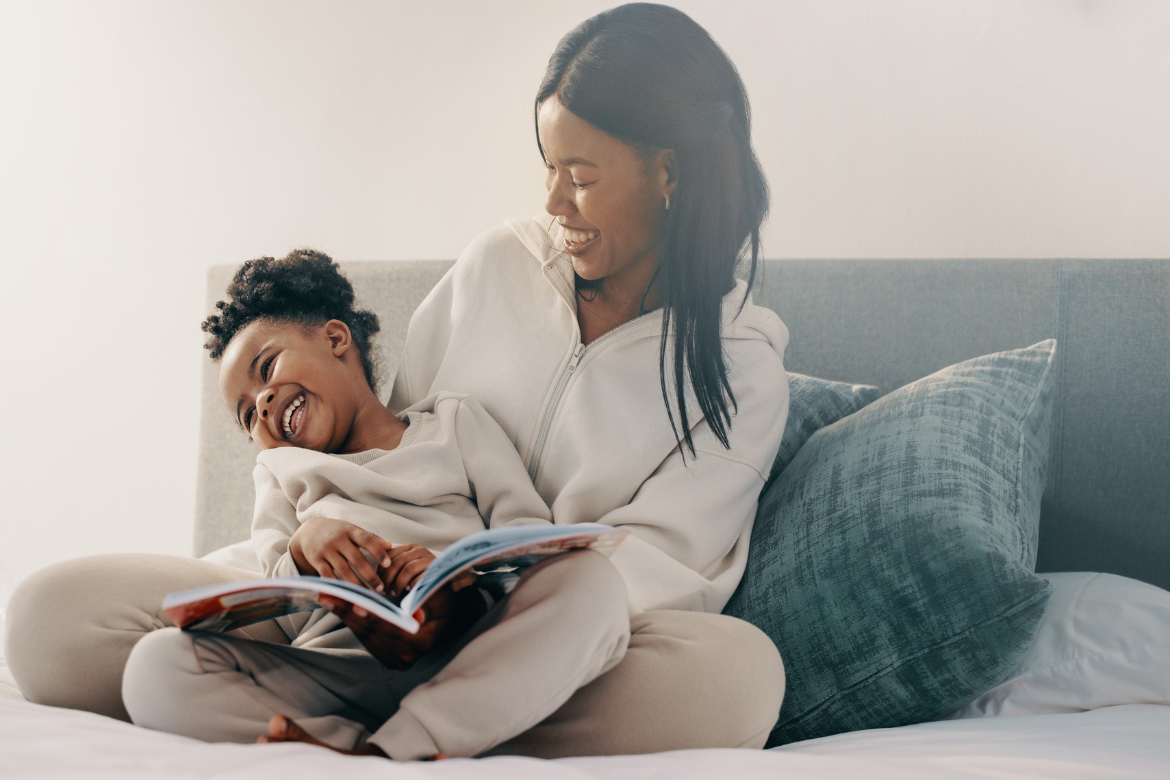 AdobeStock_562960836 v2 Woman and her daughter reading with straightened teeth after Invisalign First in Crestview Hills