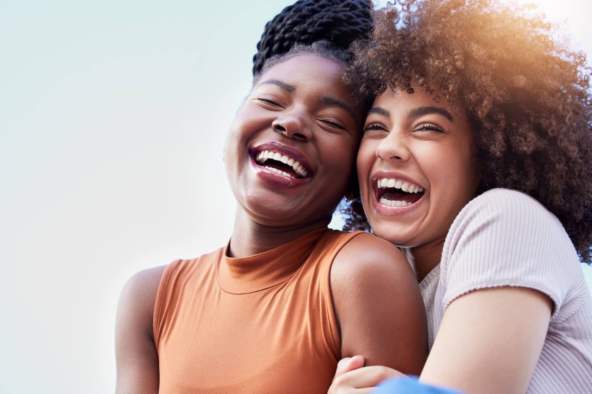 Friends laugh together without pain because they had orthodontic surgery in KY