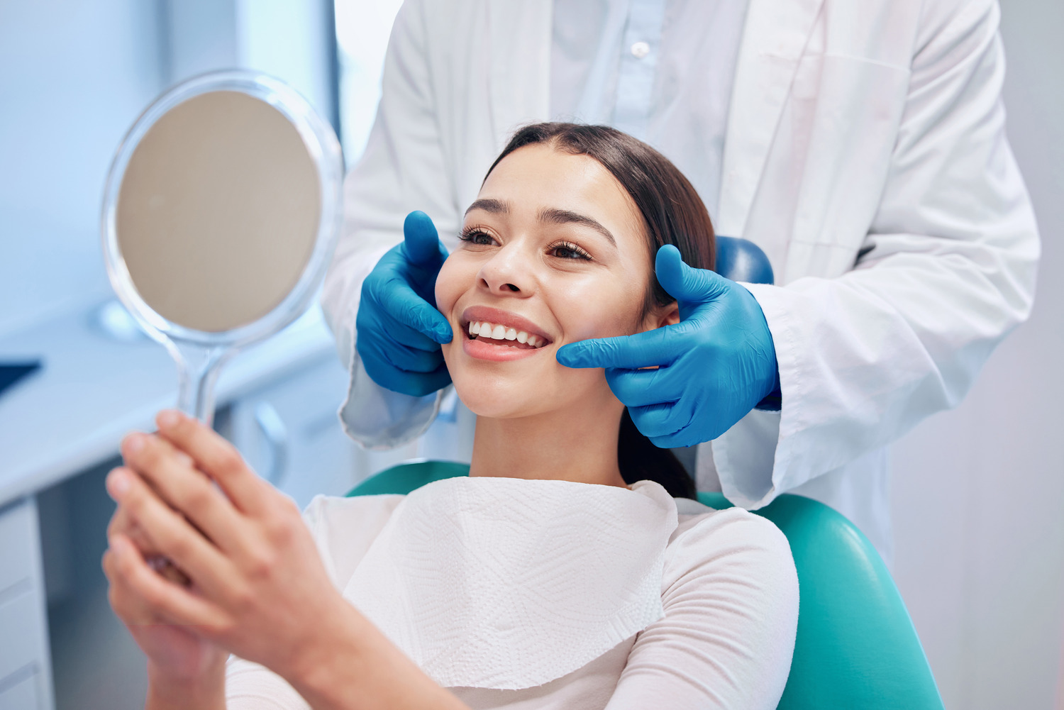 Woman looking at her perfect teeth after and orthodontic surgery in Crestview Hills KY